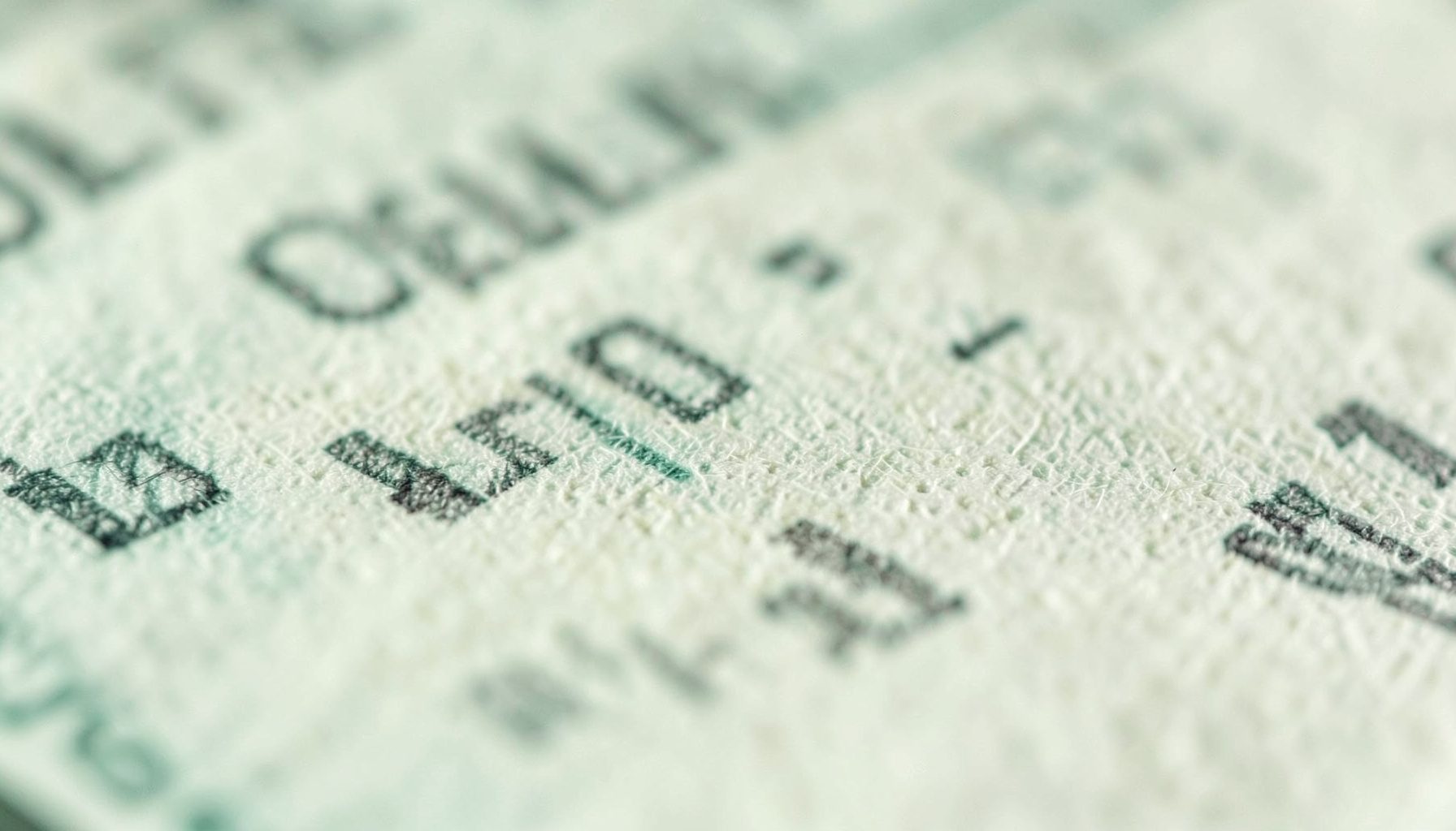 An extreme close-up of ballot paper texture, cream and grey tones, democratic process theme