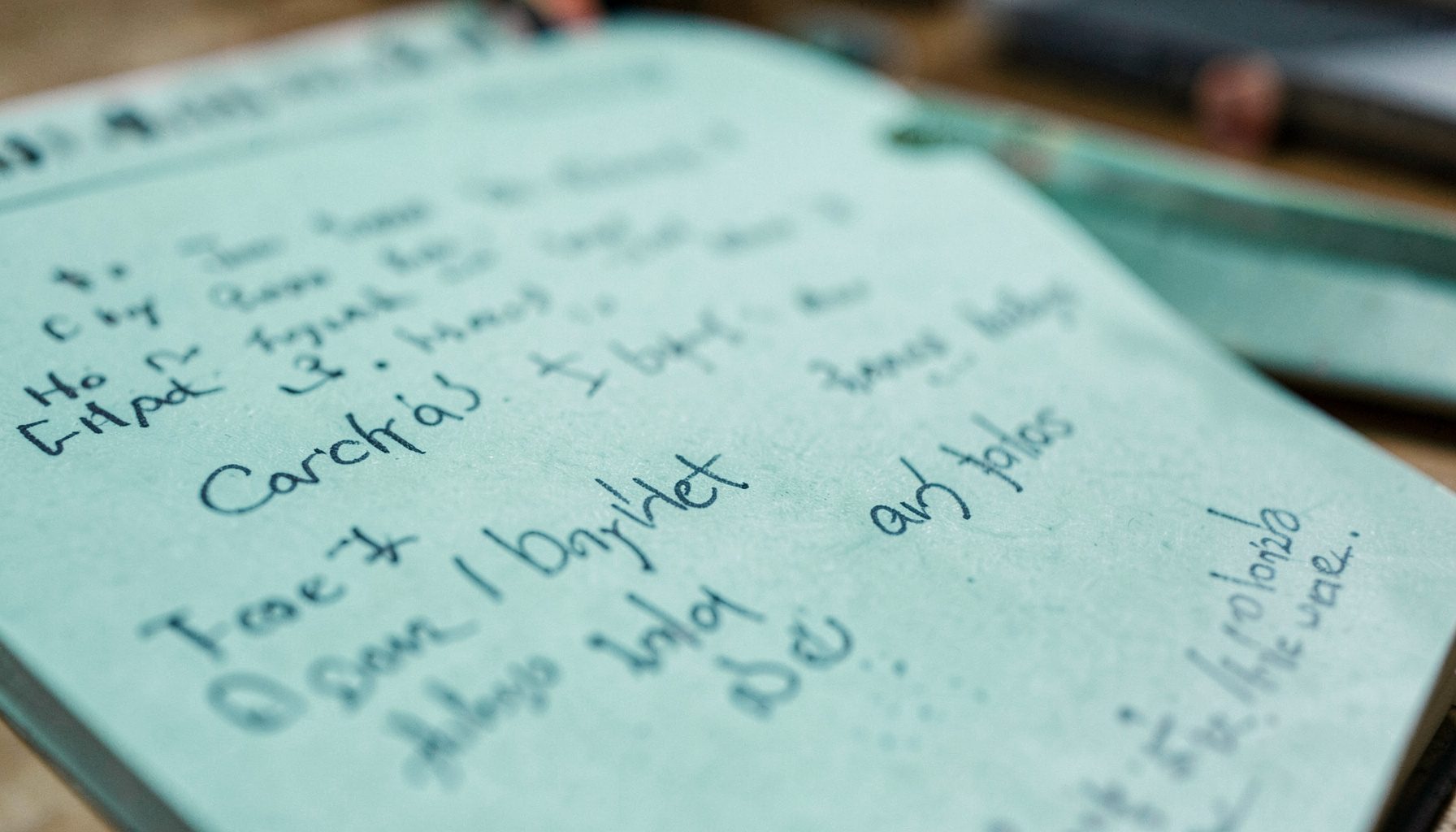 A close-up photograph of a workshop flipchart with handwritten notes, collaborative and informal setting